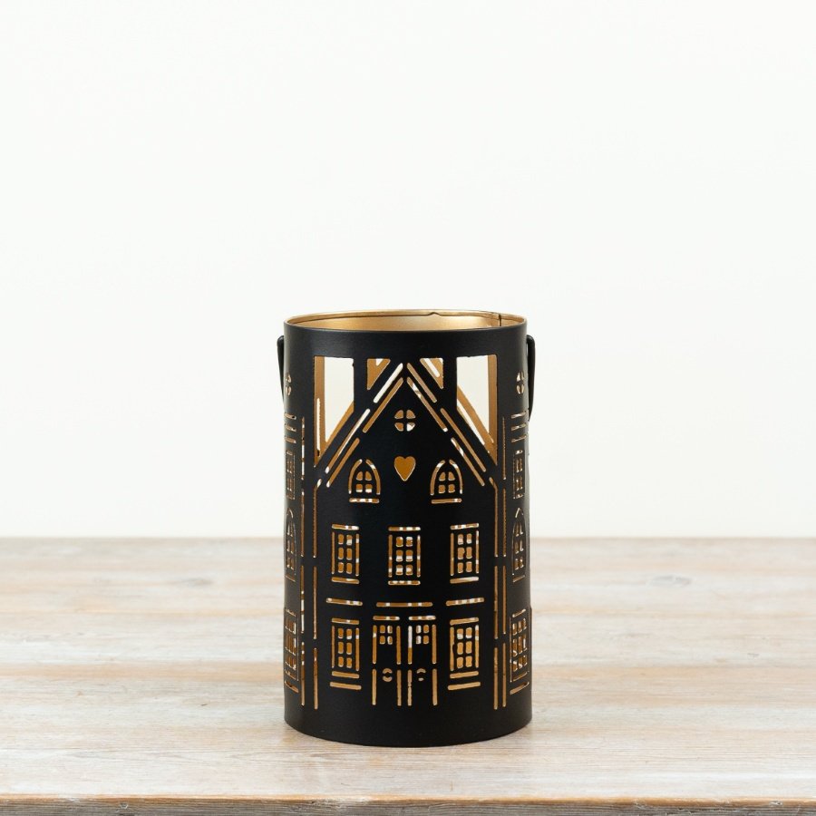 a charming cut out house candle holder 
