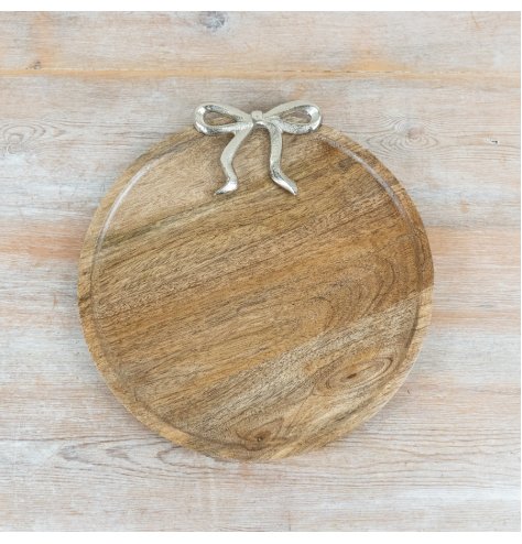 Stylish wooden plate featuring a silver bow accent design.