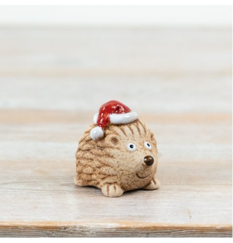 A charming ceramic hedgehog Christmas decoration, perfect for festive displays.