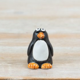 Introduce a touch of fun to your collections with this delightful ceramic penguin decoration.