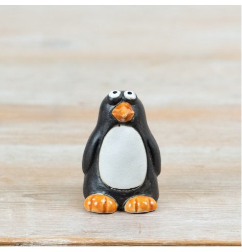 Bring charm to your seasonal décor with this delightful ceramic penguin ornament, perfect for wildlife lovers.