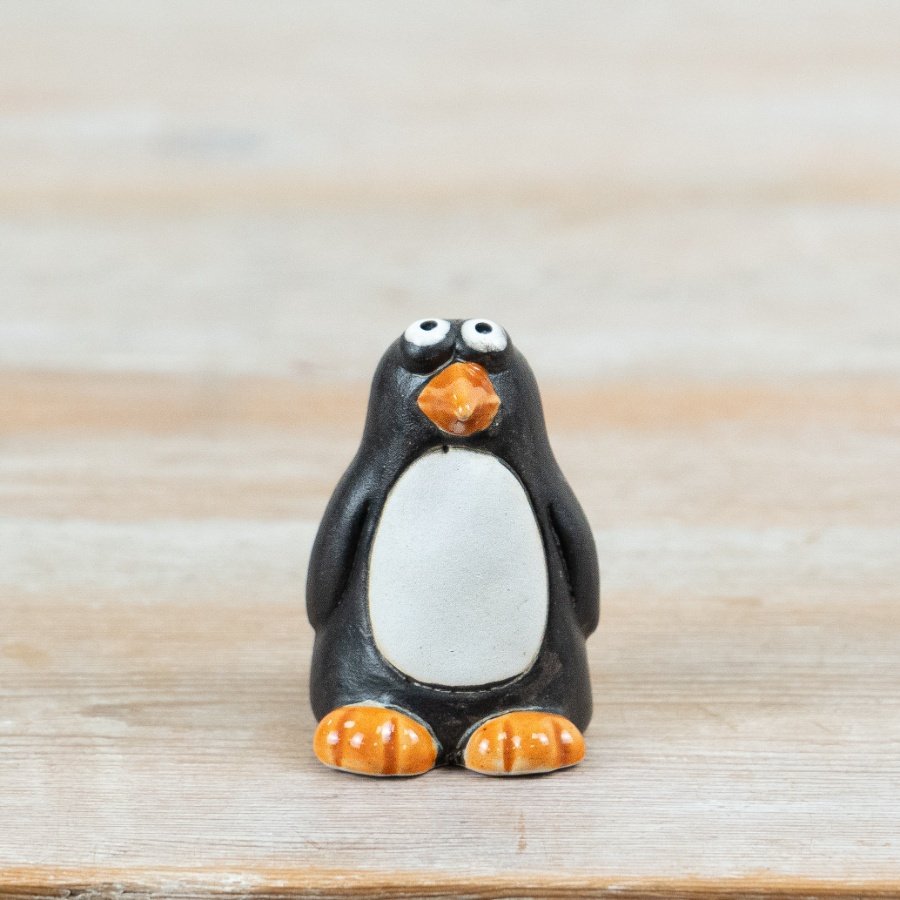 Introduce a touch of fun to your collections with this delightful ceramic penguin decoration.