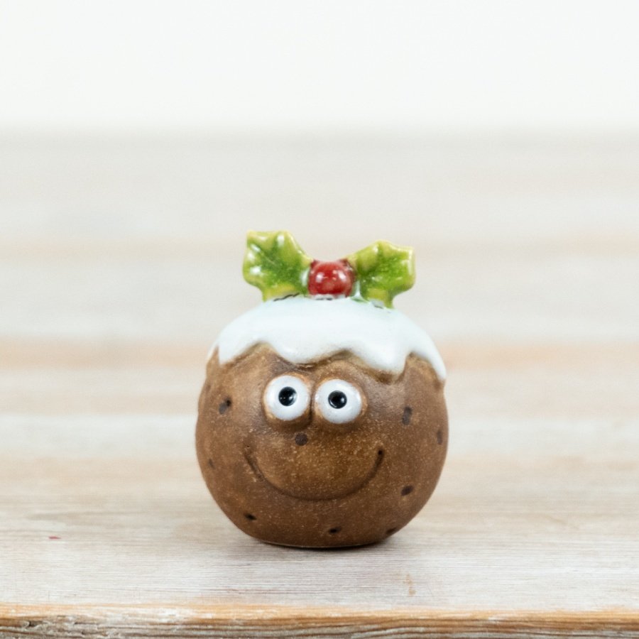 Add a playful twist to your festive collection with this charming ceramic Christmas pudding decoration.