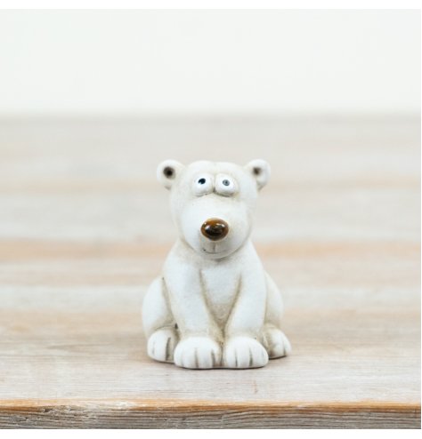 Adorable seated polar bear ornament featuring a smooth stone-like texture and charming design.