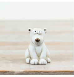 A cute polar bear ornament with a soft stone-effect finish and charming seated pose.