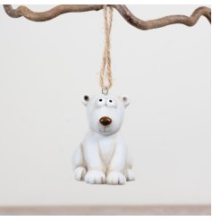 Playful polar bear ornament to hang on your tree with festive charm.