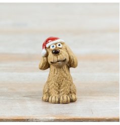 A playful Christmas dog decoration wearing a classic Santa hat. 