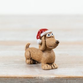 Add a touch of festive charm with this adorable dog decoration, finished in a textured stone-effect and topped with a cl