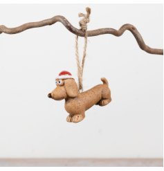 Festive and fun, this cheeky dog decoration boasts a charming textured stone-effect finish.