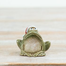 Add a touch of festive character to Christmas displays with this charming frog ornament, complete with a classic red San