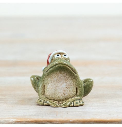 Charming frog figurine donning a Santa hat, featuring a textured stone-like finish for festive decor.