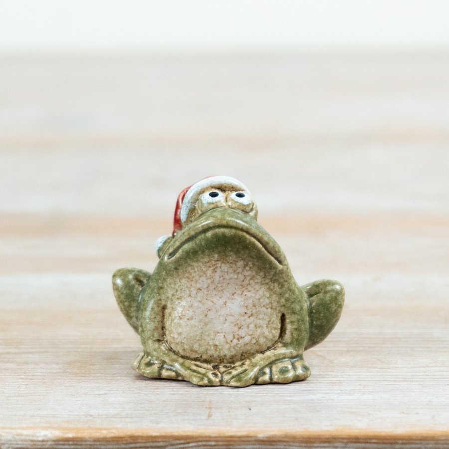 Add a touch of festive character to Christmas displays with this charming frog ornament, complete with a classic red San