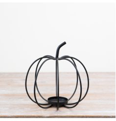 Chic black pumpkin-shaped candle holder for a stylish touch to any space.