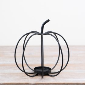 Add a touch of autumn charm with this black metal pumpkin candle holder