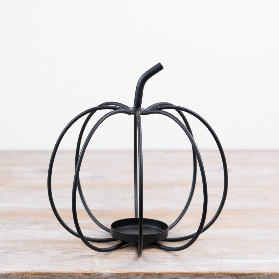 Add a touch of autumn charm with this black metal pumpkin candle holder