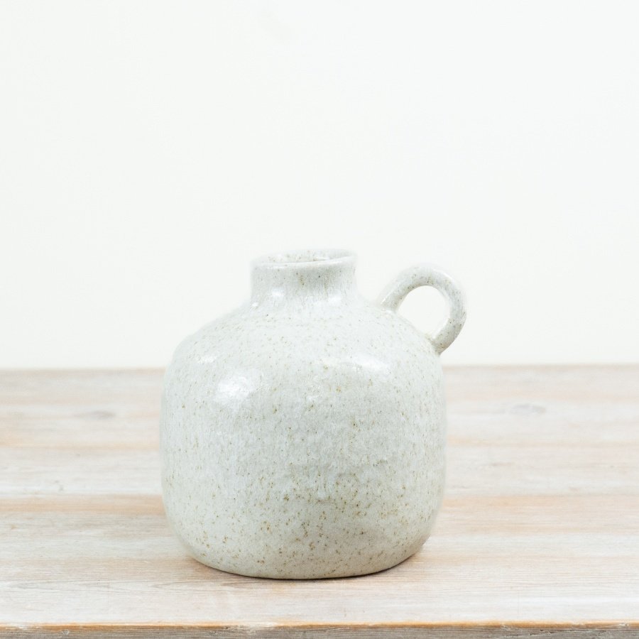 a charming white vase with small, handle 