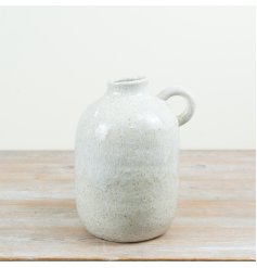 A stoneware jug-style vase with a soft rounded shape, subtle speckled glaze and practical side handle