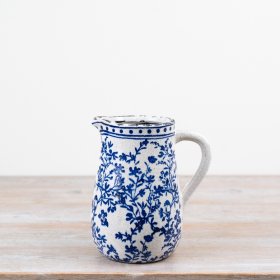 Blue and white ceramic jug featuring a floral pattern and a softly aged, distressed look.