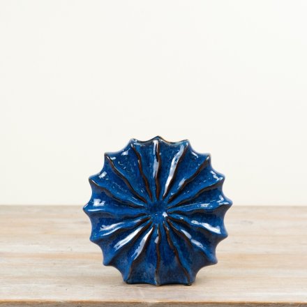 Finished in a vibrant blue glaze, this 22cm vase features a sculpted shell-inspired shape with raised radial texture