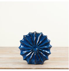 Finished in a vibrant blue glaze, this 22cm vase features a sculpted shell-inspired shape with raised radial texture