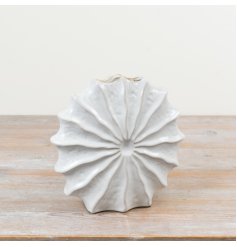 A bold, sculptural ceramic vase with a rippled, fan-style design and soft white glazed finish.