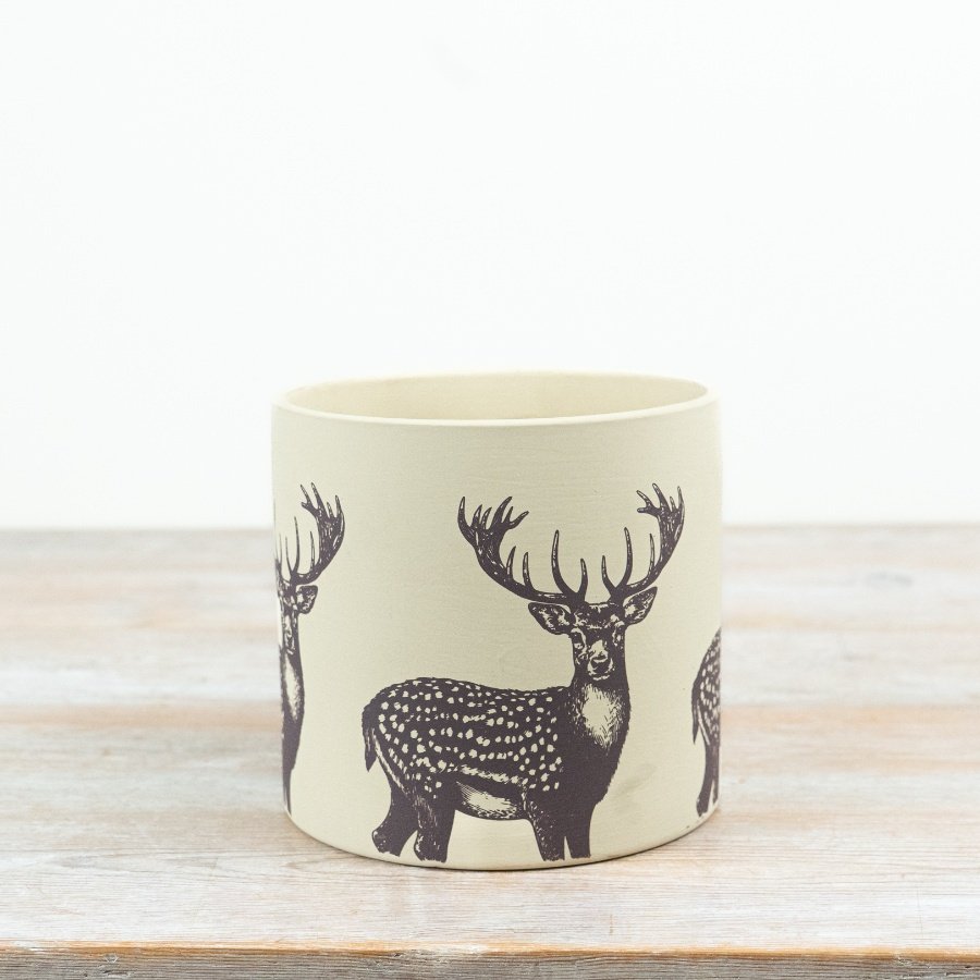 Cute terracotta pot shaped like a reindeer
