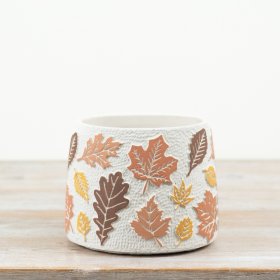 This textured cement planter features an all-over autumn leaf design in warm, earthy tones, bringing instant charm