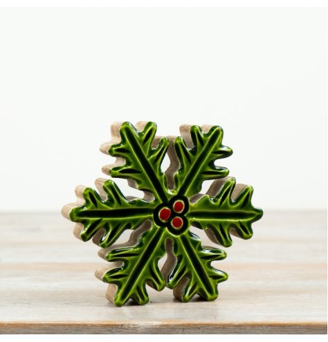 A charming festive decoration featuring glossy green enamel holly leaves 