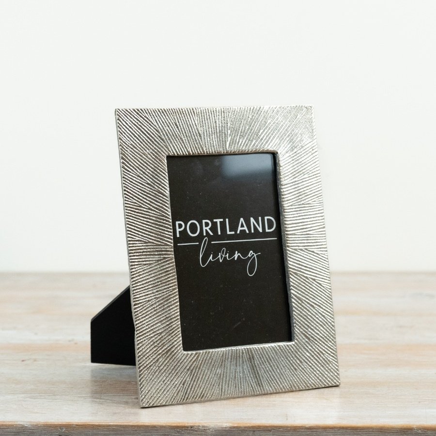 A striking photo frame with a textured metallic effect surround and clean black inner mount.