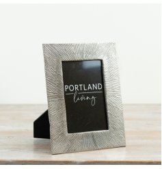 A bold decorative photo frame with a textured metallic-look surround that adds instant impact to any display. 