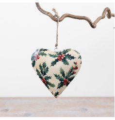 A classic heart-shaped hanging decoration features a classic holly and berry design in traditional festive colours,
