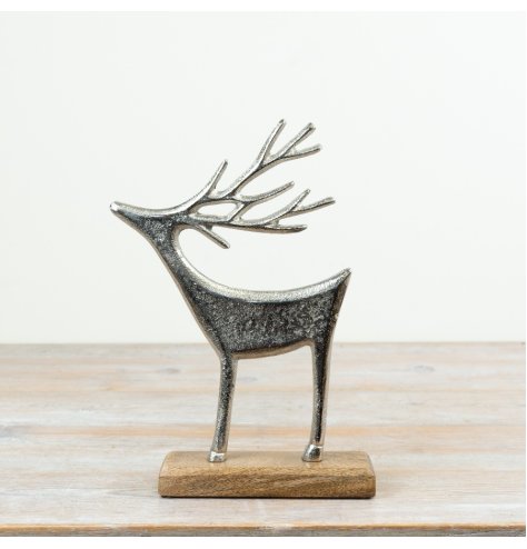 A festive aluminium reindeer decoration mounted on a natural mango wood base.