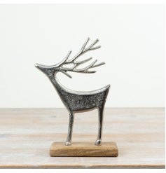A decorative aluminium reindeer ornament mounted on a mango wood base
