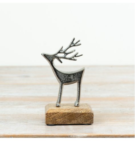 A festive aluminium reindeer decoration mounted on a natural mango wood base.