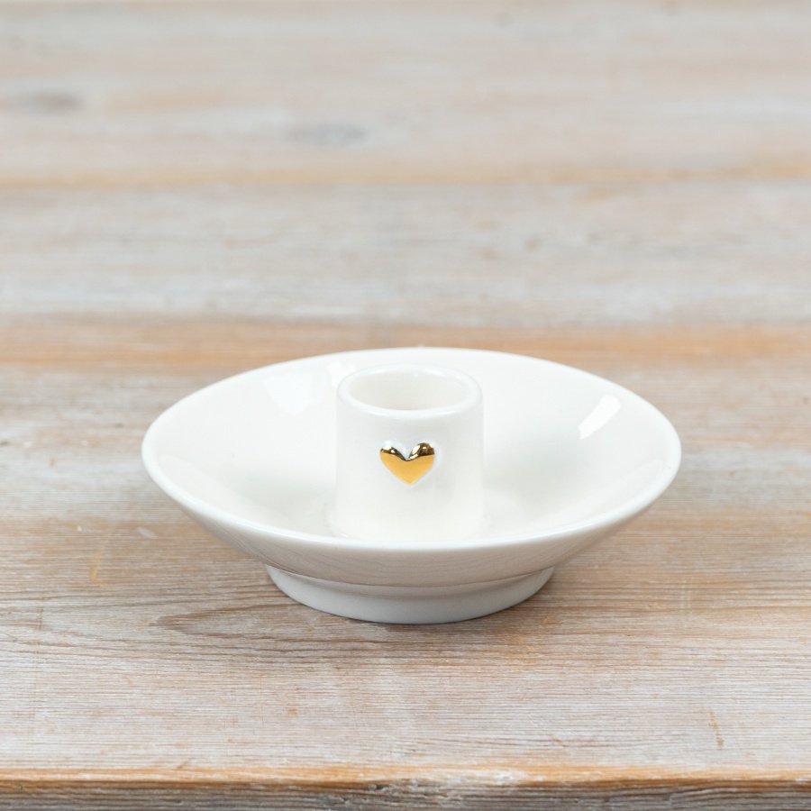 Elegant candle holder featuring a delicate gold heart accent.