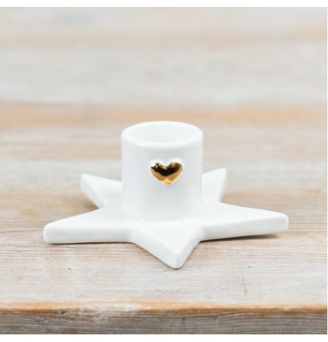 Bring cozy charm to any space with this elegant heart-shaped star taper candle holder.
