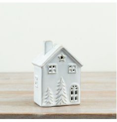 Cute 13cm porcelain LED house emitting a cozy light, powered by three LR44 batteries.