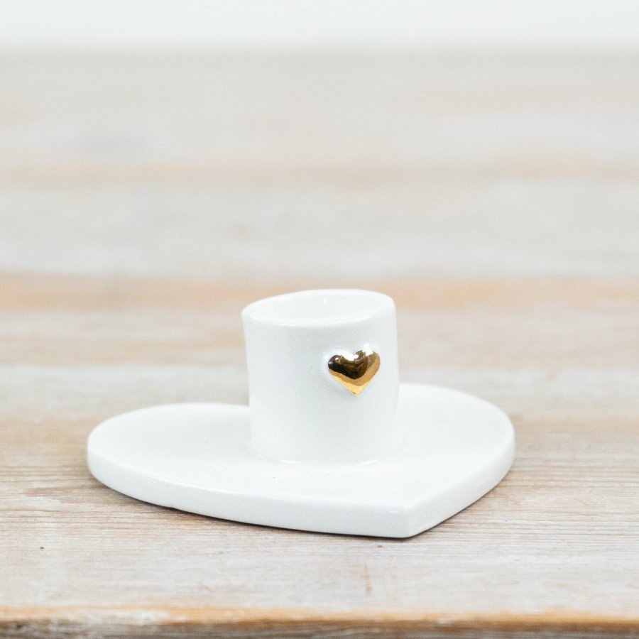 Add subtle charm and sentiment to your interiors range with this porcelain heart-based candle holder.