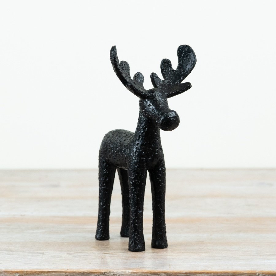 Introduce bold, contemporary styling to your collection with this striking black moose ornament.