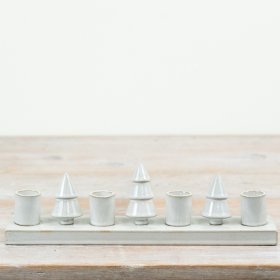 Decorative ceramic candle holder featuring Christmas tree shapes along a rectangular base