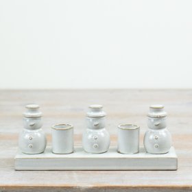 Beautifully presented on a matching rectangular base, the piece features three charming snowman figures