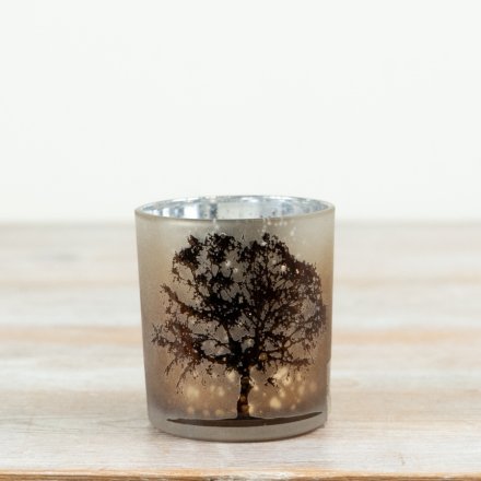 Add a warm, atmospheric glow to seasonal and year-round interiors with this elegant frosted glass t-light holder.