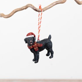 Adorable black dog dressed in a warm scarf and Santa hat, ideal for your festive tree