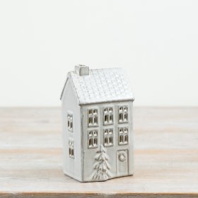 Decorative ceramic house featuring a natural glaze finish, window cut-outs and a raised 3D Christmas tree detail.