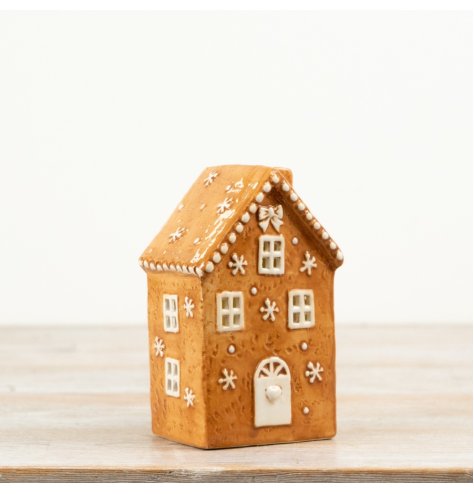 A delightful light-up gingerbread house featuring icing-style detailing and warm LED illumination