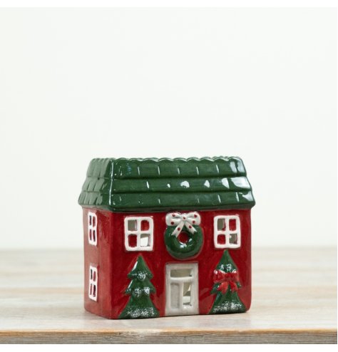 Bring a warm festive glow to Christmas displays with this charming house-shaped tealight holder. 