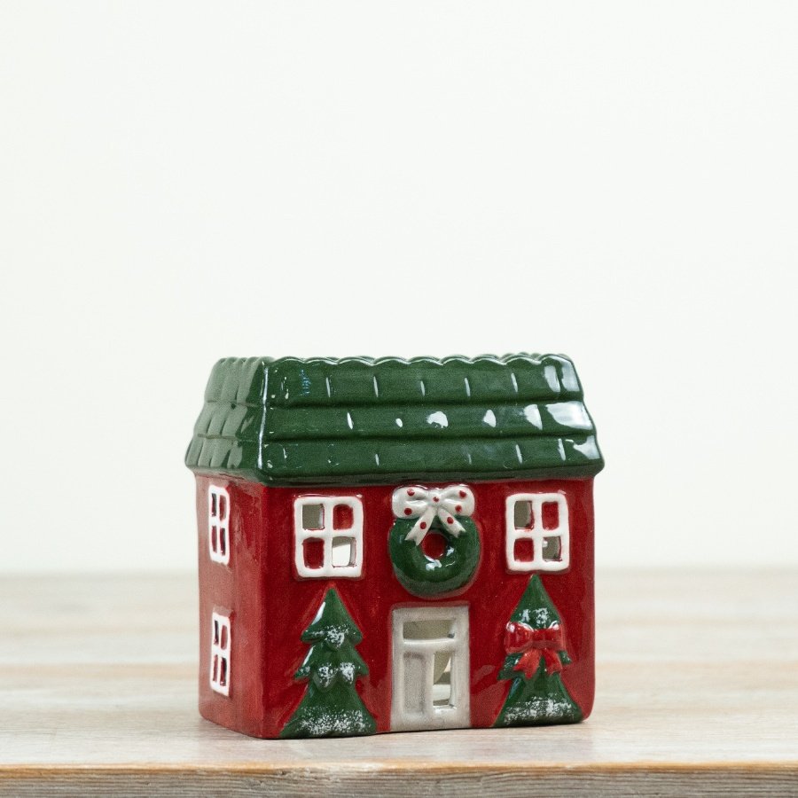 Decorative ceramic tealight holder shaped as a festive house