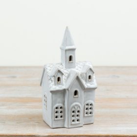 Decorative ceramic church with detailed window cut-outs and an integrated LED light to create a soft illuminated display