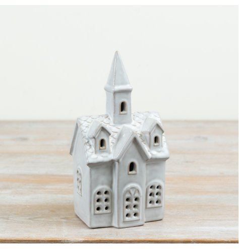 A charming ceramic church decoration designed to bring a peaceful festive glow to Christmas displays