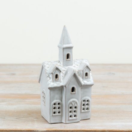 A charming ceramic church decoration designed to bring a peaceful festive glow to Christmas displays
